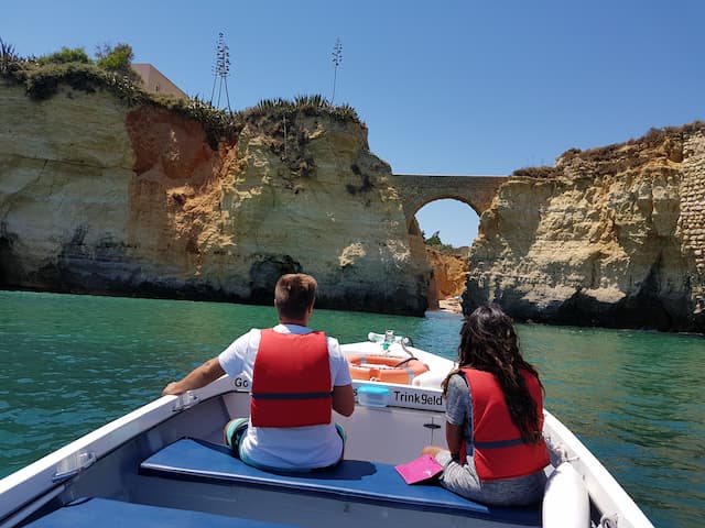 Couple on a boat under the Pinhao Bridge in Lagos